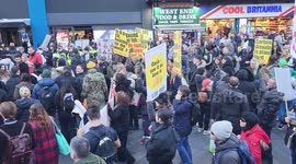 Protesters against a cashless society pass through Leicester Square letting off smoke flares