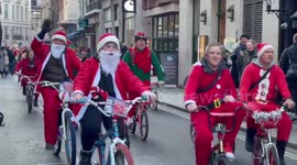 Hundreds of Santas ride through London