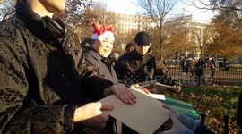 Dissident artist Ai Weiwei signs A4 paper at Speakers Corner for Human Rights Day