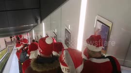 Dozens of Santas from Santacon on Elizabeth Line in London