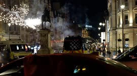 Football supporters shoot fireworks into the street narrowly missing police vans after Morocco game