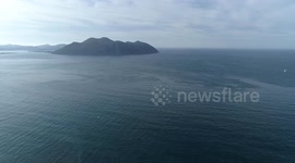 Flying over and near impressive cliffs in Laredo at sunset with danger by drone