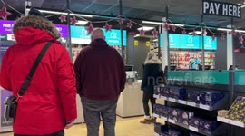 Shoppers queue to collect products at an Argos shop in Guiseley, UK.