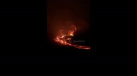 The flowing lava of Mauna Loa's illuminates the darkness of the night.