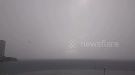 Two lighting bolts striking the sea and light up the water during a winter storm in Benidorm, Spain
