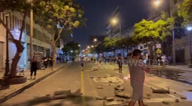 Fires and debris like the street in Lima as people protest the Peru government