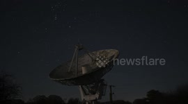 Fascinating moment huge telescope moves as the earth rotates with the Geminid meteor shower unfolding in the background in Shropshire, England