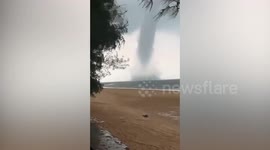 Massive waterspout tornado tears along beach in Indonesia