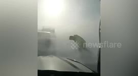 Police officers almost blown off their feet as snow and gusty winds strike China