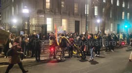 NHS strikers protest into the night Outside Number 10. With an interview from. Male Nurse and a supporter.
