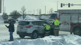 Several people from the Fargo fire department, talking to a passenger that was rear ended