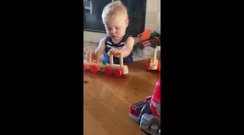 Brilliant kiddo figures out and puts together his toy train ALL BY HIMSELF!