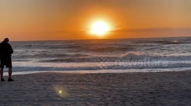 Sunset Watchers Bundle Up Against Unusual Cold in Southwest Florida