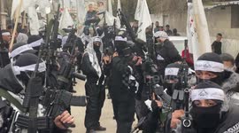 Palestinian gunmen from the Balata Brigade of the Fatah movement carry their weapons and show off their strength
