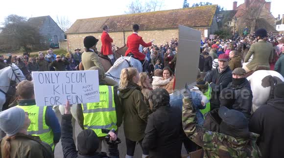 Black-clad protesters demonstrate at annual Boxing Day Hunt in Lacock, Wiltshire