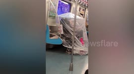 Man in China wears self-made tent on tube to shield himself against COVID