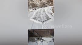 Villager in China use homemade clearing tool to remove snow on road