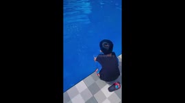 The cute child tried to push his father into the pool, then he fell as well!