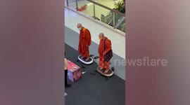 Unusual sighting: Buddhist monks try vibrating machines in mall