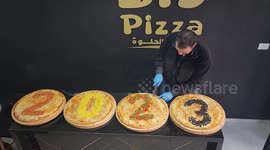 Palestinians make 2023 pizza to celebrate the New Year