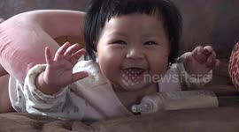 A very cute adorable kid looks like she is auditioning for the I can fly scene in Titanic movie.