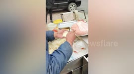 Skilful Chinese vendor impresses customer by wrapping wontons at fast speed