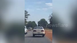 Car cruises on highway with dangerously slanted wheel