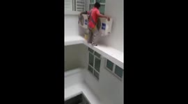 Man installs air conditioner unit outside 16th floor without wearing a harness