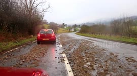 Road in the Lake District strewn with debris after storms