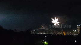 Fireworks and stormclouds create stunning display over Sydney Harbour Bridge