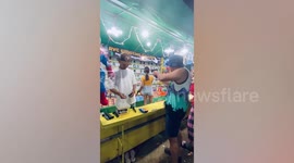 Competitive fairgoer shoots all balls at firing range booth in the Philippines