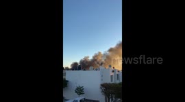 Smoke billows across sky after security forces arrest son of drug lord 'El Chapo'