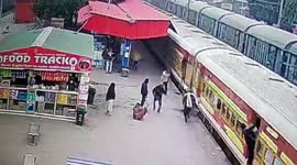 Alert cops rescue man dragged along after falling while boarding a moving train in northern India