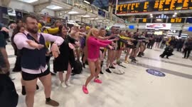 People do the Macarena in London Liverpool St for No Trousers day