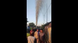 Gas burst heavily upwards the sky while drilling for borewell water pump