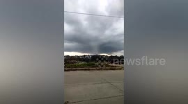 Scary dark funnel cloud swirls over buildings in the Philippines