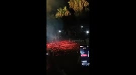 Vietnamese locals dance across burning embers during New Year festival