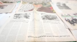 An elderly Palestinian, Talal Taha, 75, collects newspapers at his home