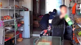 Woman distracts Chinese shopkeeper while partner in crime steals cigarettes