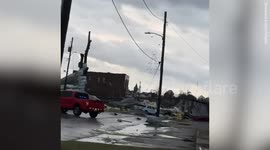 Buildings destroyed and debris strewn on roads after tornado sweeps through Alabama