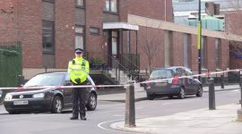 Police remain on scene on Sunday of drive-by shooting outside London church that injured six, including two children, as manhunt continues
