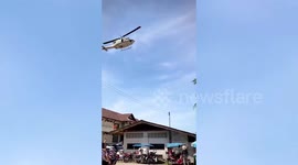 Helicopter blows away stalls while celebrating children's event in Thailand