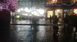 People in Covent Garden clap as a marriage proposal goes very successfully