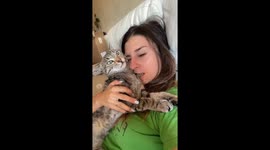 The playful owner teased her cat by biting her!