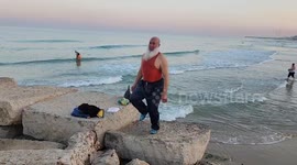 Elderly Palestinians swim in the Mediterranean sea during the winter, in Beit Lahia in the northern Gaza Strip