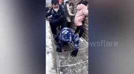 Great crawl of China! Boy struggles to walk as ice covers Chinese landmark