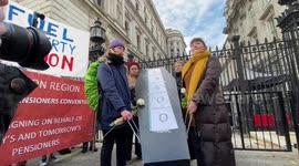 Funeral protest outside Downing Street for 13400 excess deaths due to fuel poverty.