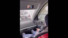 The child rubs his dirty shoe into his dad's car compartment.