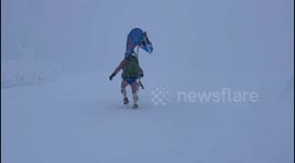 A fundraiser called 'Speedo Mick' who walks around Britain in just a pair of swimming trunks has made it to the top of Ben Nevis