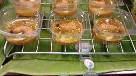 Live weevil larvae served bathed in sauce in shot glasses